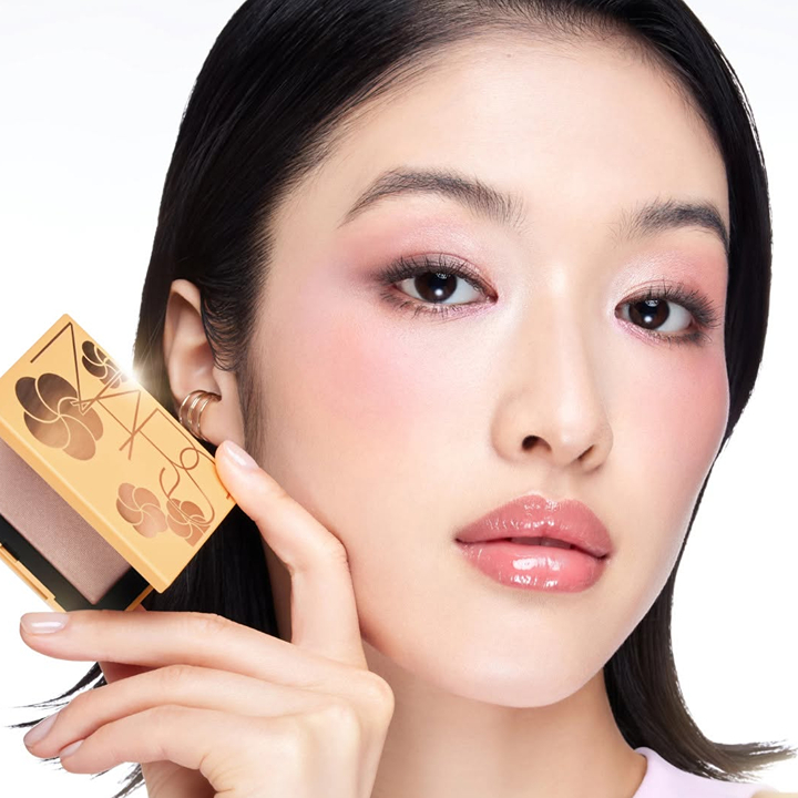 woman with nars makeup palette from sephora on summer sale get discounts on makeup this summer