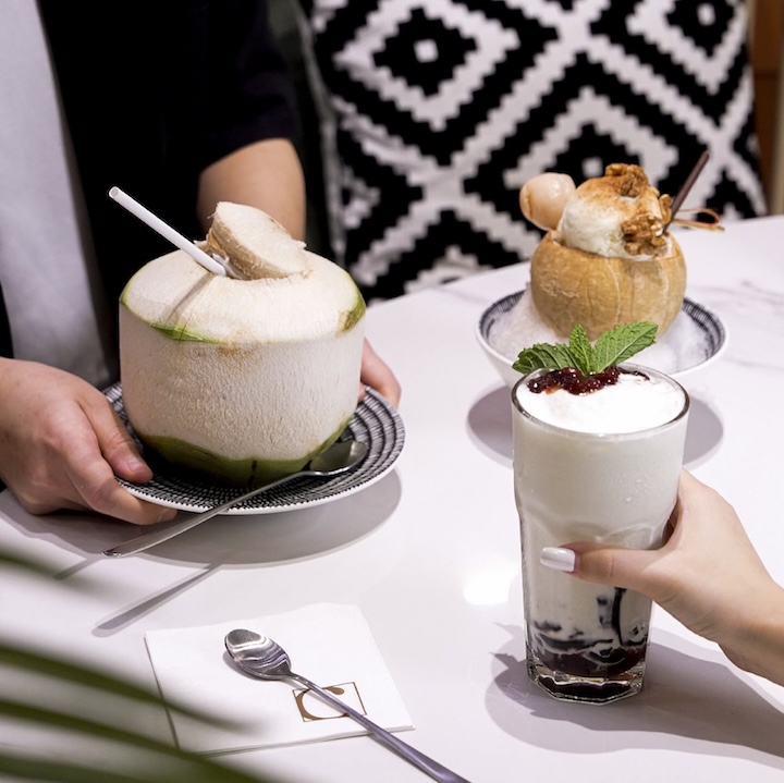 chatterbox cafe coconut series on a table, including coconut ice cream, coconut drink and fresh young coconut