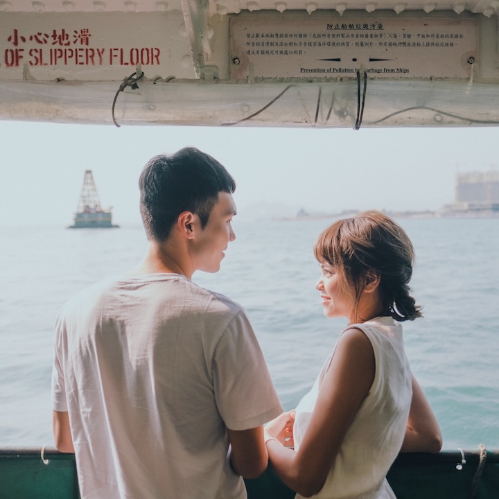 couple on a star ferry in hong kong on a date