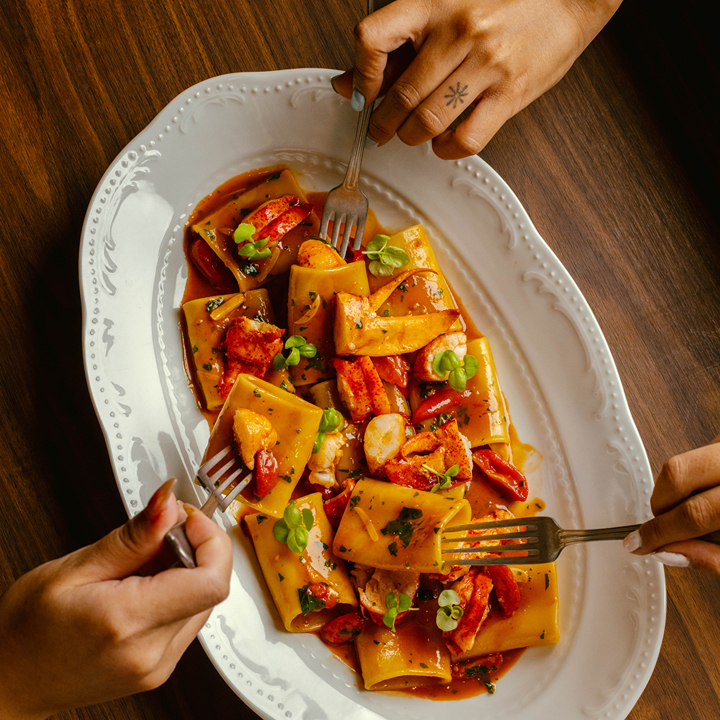 people sharing a pasta dish at Ninetta, new Italian restaurant in Central Hong Kong this August 2026