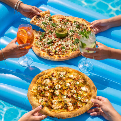 people taking pizza slices and drinking on a pool floaty in Hong Kong, where to get the best pizza in Hong Kong