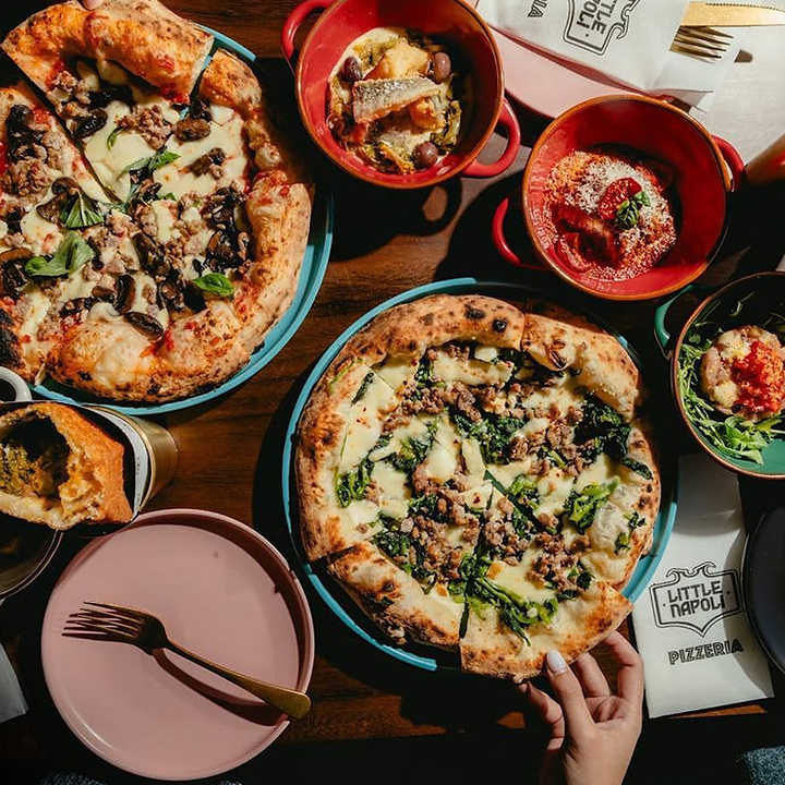 spread of pizza, starters and pizza fritta from Little Napoli where you can get Authentic Neapolitan Pizza in Hong Kong
