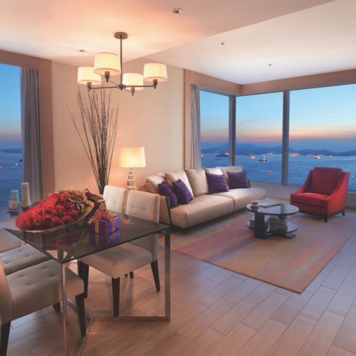 A living room in The HarbourView Place with view of the Victoria Harbour from Kowloon side