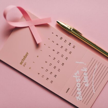 Pink ribbon with calendar promoting breast cancer awareness in October 2026