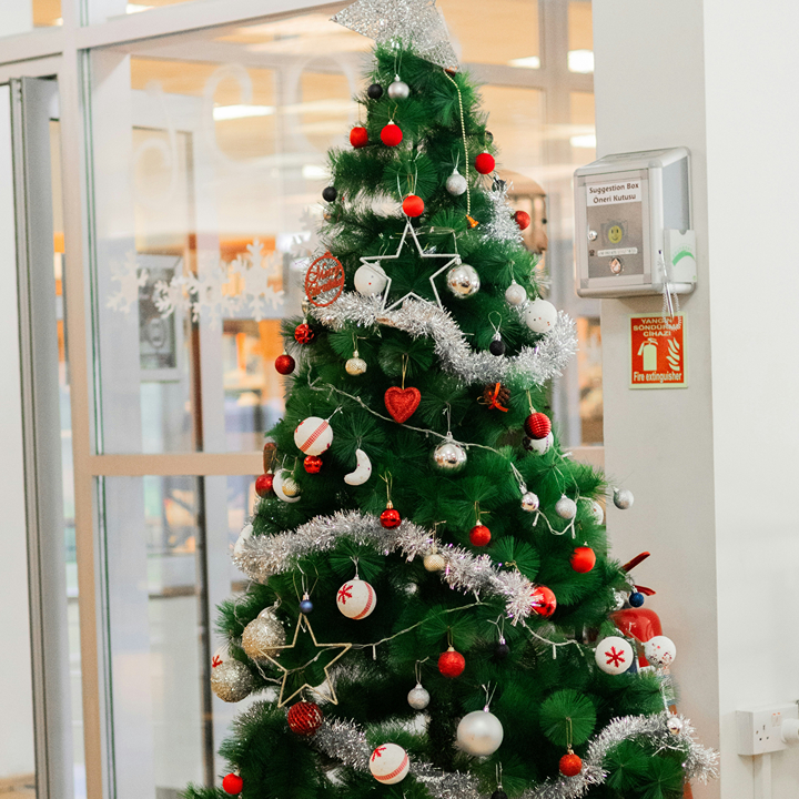 Artificial christmas tree decorated with ornaments, star and tinsel in Hong Kong