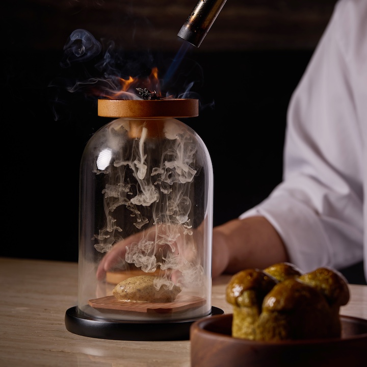 the chef prepares a signature dish at the revamped akoma restaurants in Hong Kong