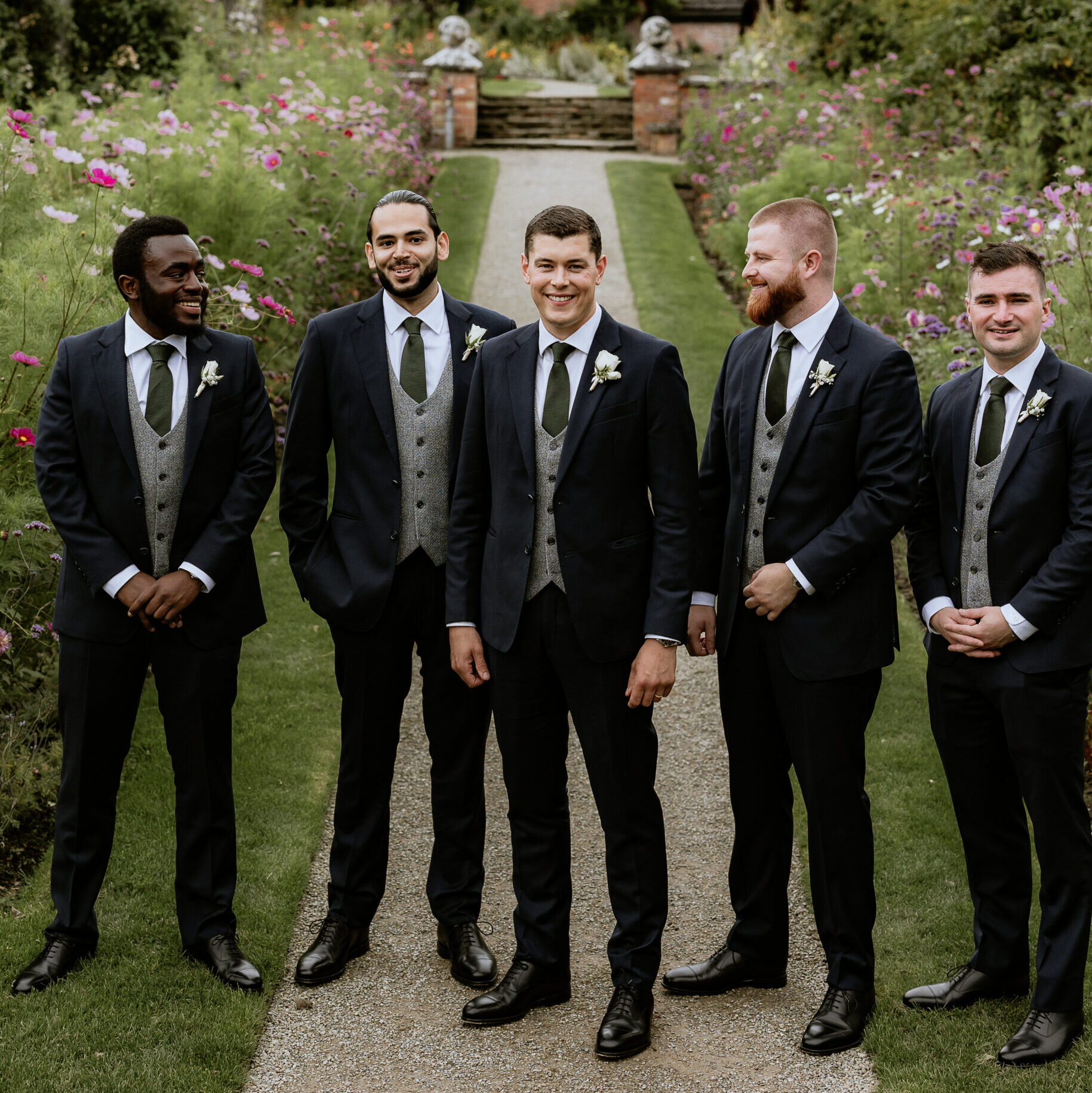 groomsmen at a wedding wearing custom tailored suits from raja fashions